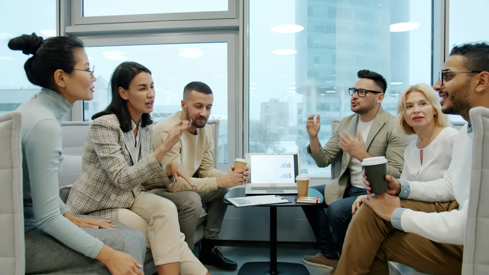 A team meeting around a table in a bright modern office